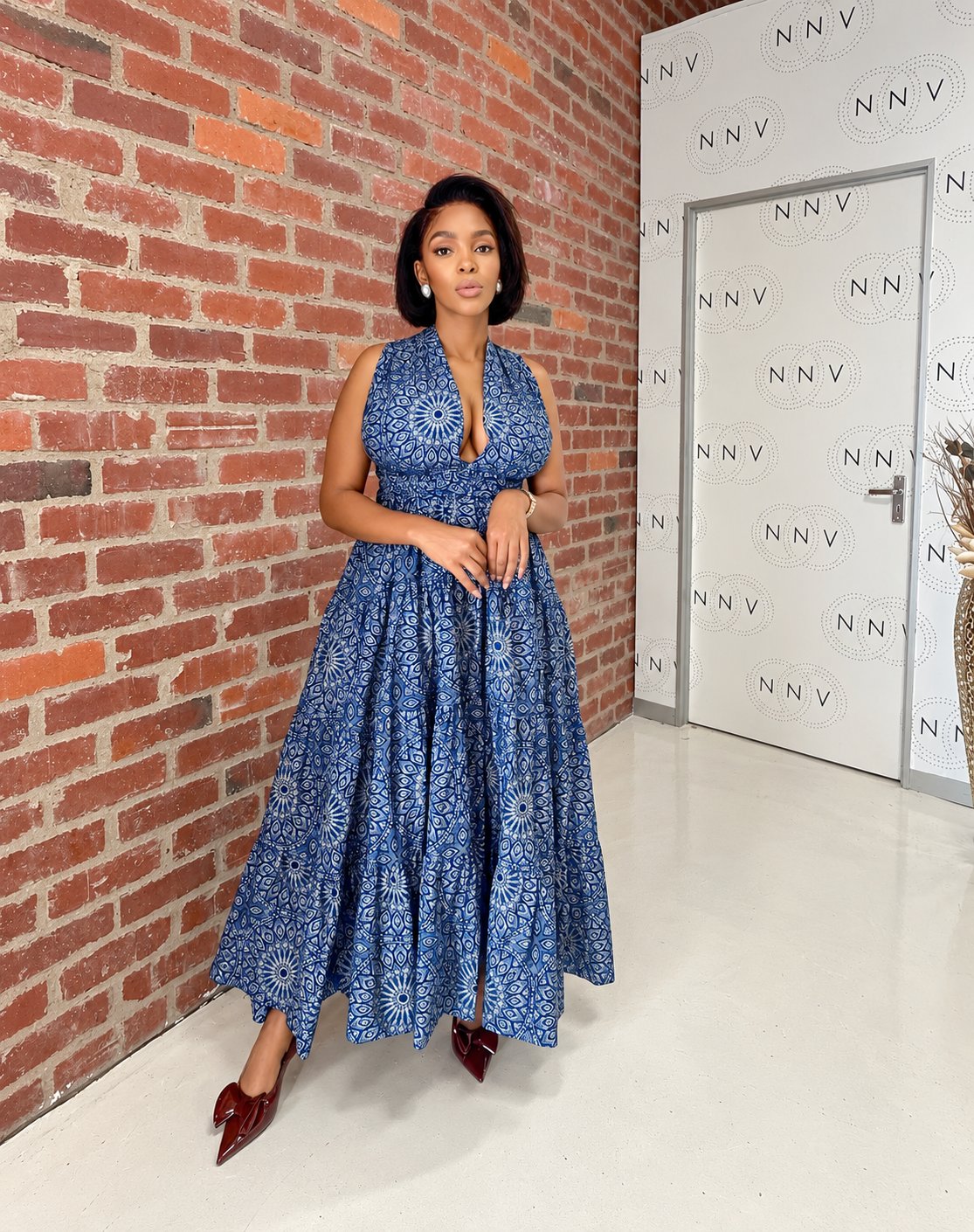 Woman wearing blue shweshwe halter maxi dress with tiered skirt